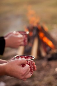Holding Red Mug By Campfire.